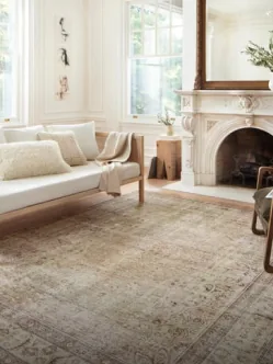 A faded vintage carpet in a sitting room