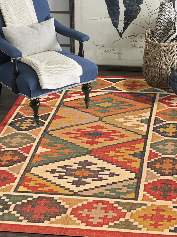 A diamond-pattern kilim under a blue armchair